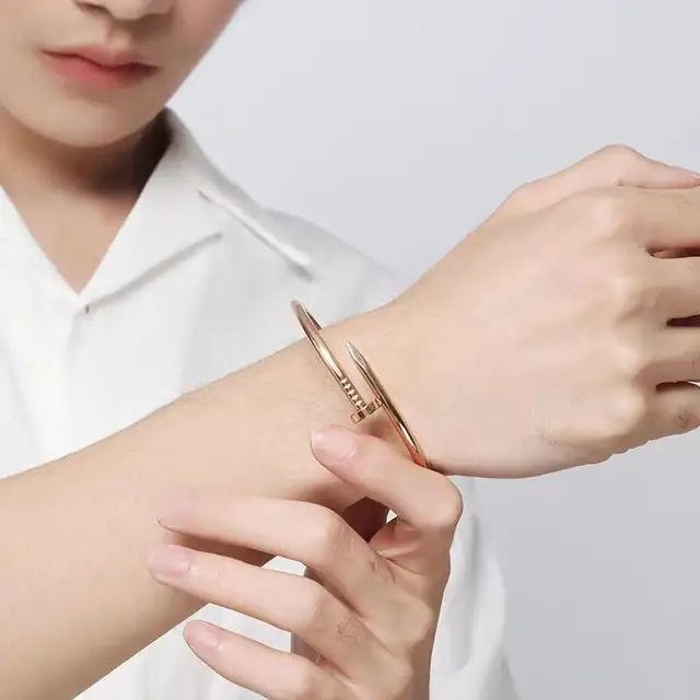 A polished rose gold nailhead anti tarnish stainless steel waterproof cuff bracelet