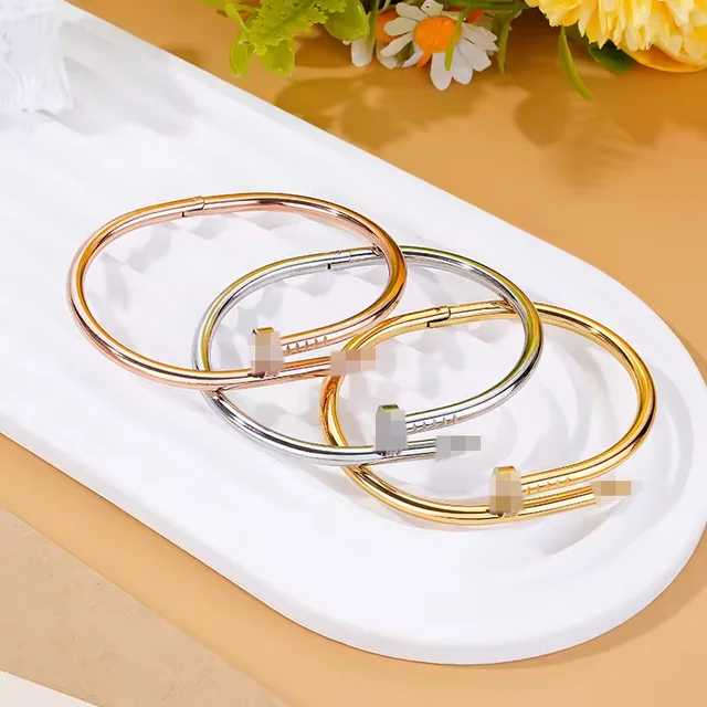 A polished rose gold nailhead anti tarnish stainless steel waterproof cuff bracelet