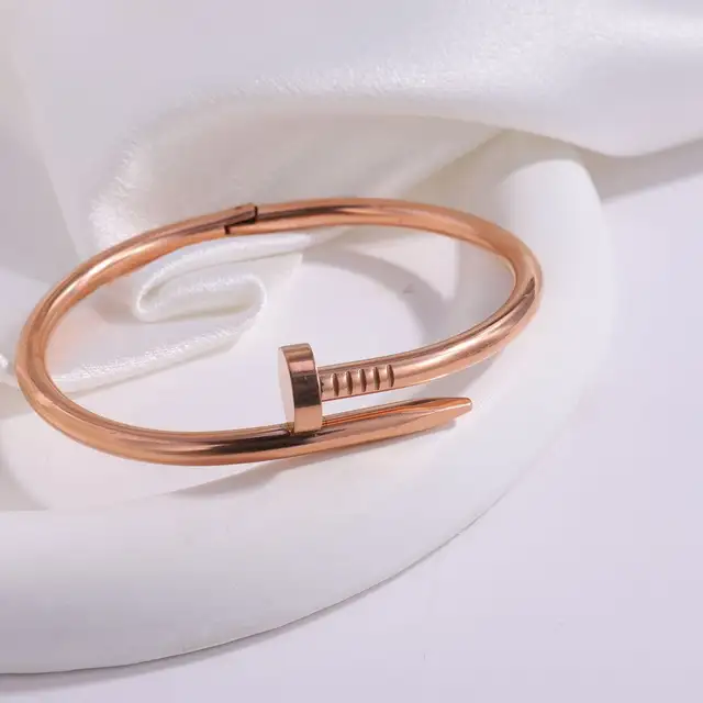 A polished rose gold nailhead anti tarnish stainless steel waterproof cuff bracelet