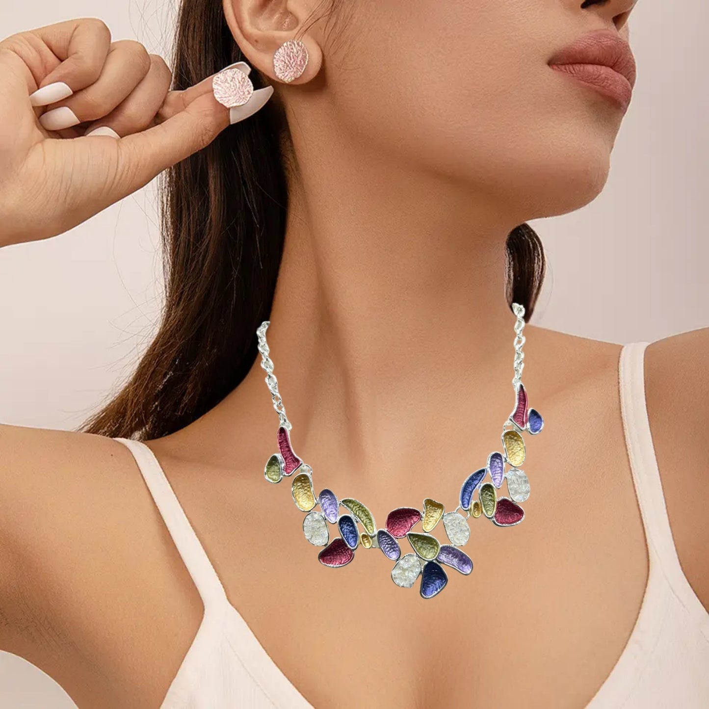 A vibrant multicolor statement necklace with purple, gold, red, and green enamel accents on an adjustable silver-tone chain