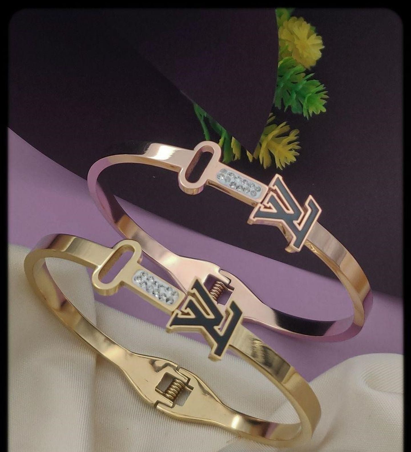 Close-up of a rose gold bracelet featuring a sleek key and initial design, with sparkling accents, perfect for stylish women.