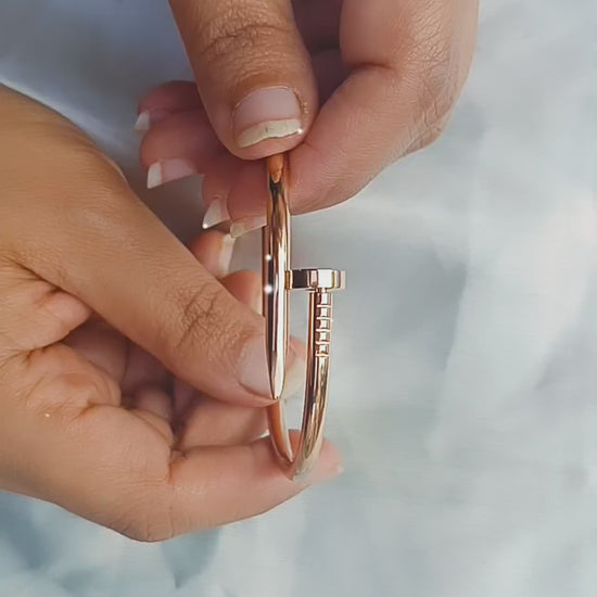 A polished rose gold nailhead anti tarnish stainless steel waterproof cuff bracelet